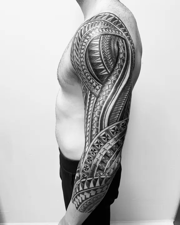 Tatuaje tribal polinesio en hombro y brazo, diseñado a mano alzada por Leo Martínez en A Sailor's Grave Tattoo, Granollers (Barcelona).