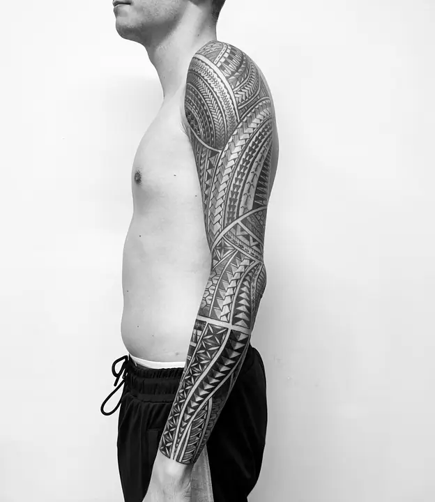 Tatuaje tribal polinesio en manga completa de brazo, diseñado a mano alzada por Leo Martínez en A Sailor's Grave Tattoo, Granollers (Barcelona).