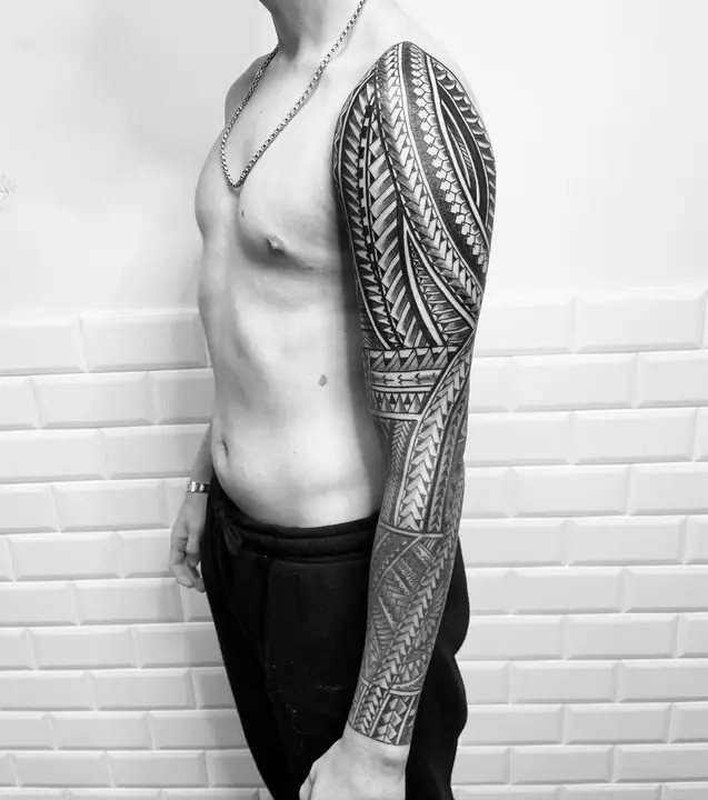 Tatuaje tribal polinesio en manga completa de brazo, diseñado a mano alzada por Leo Martínez en A Sailor's Grave Tattoo, Granollers (Barcelona).