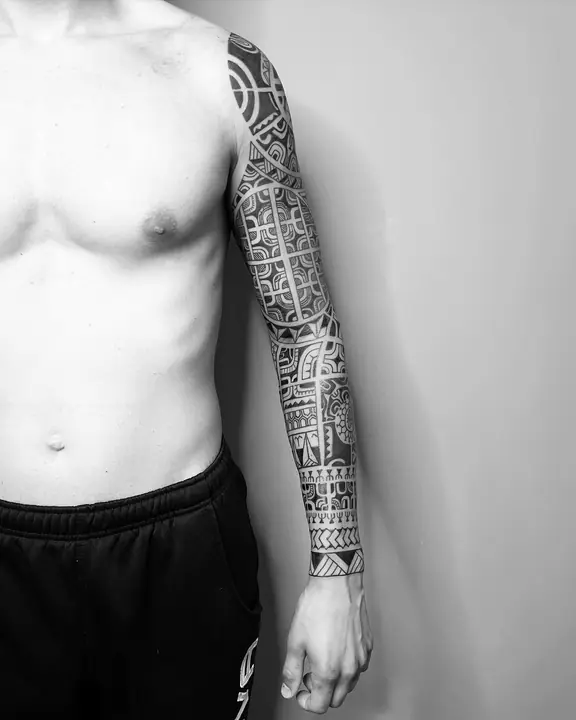 Tatuaje tribal polinesio en manga completa de brazo, diseñado a mano alzada por Leo Martínez en A Sailor's Grave Tattoo, Granollers (Barcelona).